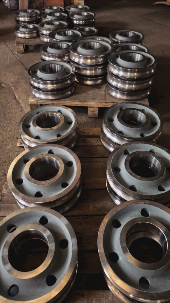 Machined surface detail of grooved sheave with precision inner bore and bolt holes