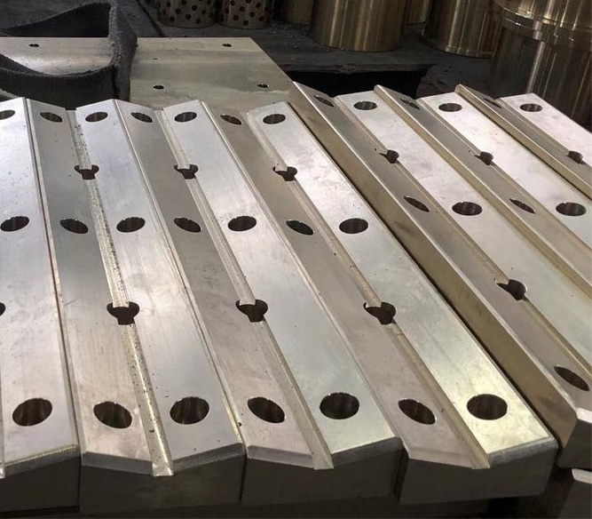 Custom bronze wear plates and guide rails with machined grooves and mounting holes