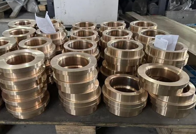 Custom flanged and stepped bronze bushings after CNC machining