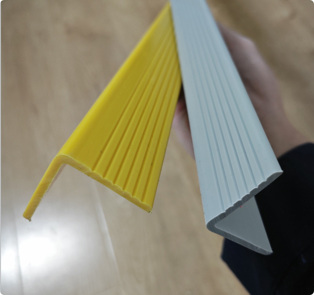 Custom rigid PVC angle profiles in yellow and grey with ribbed surfaces