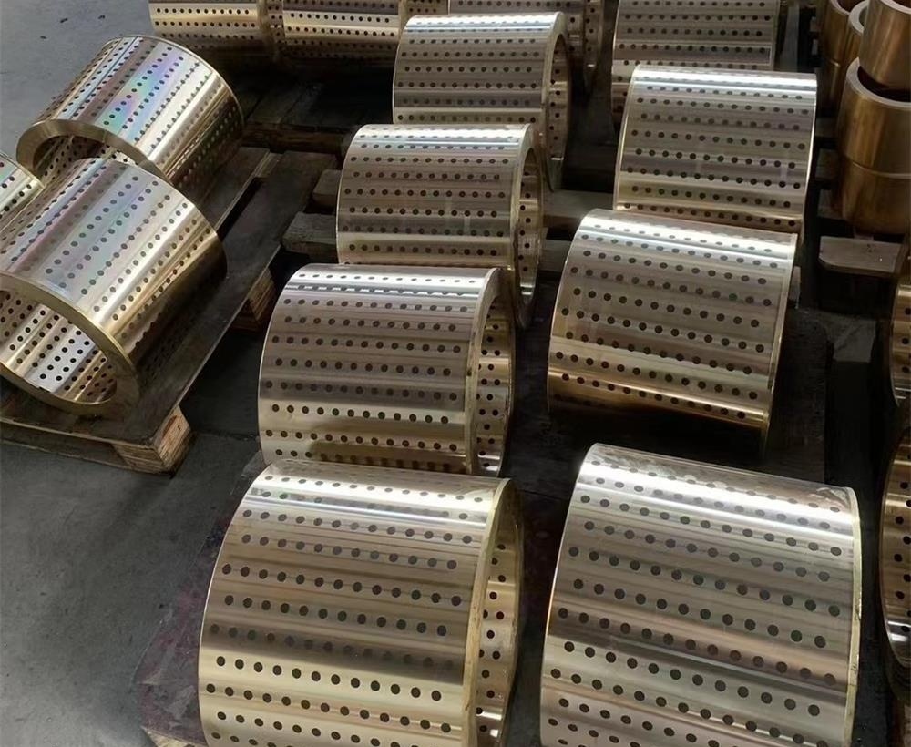 Perforated bronze bushings with lubrication holes and oil grooves